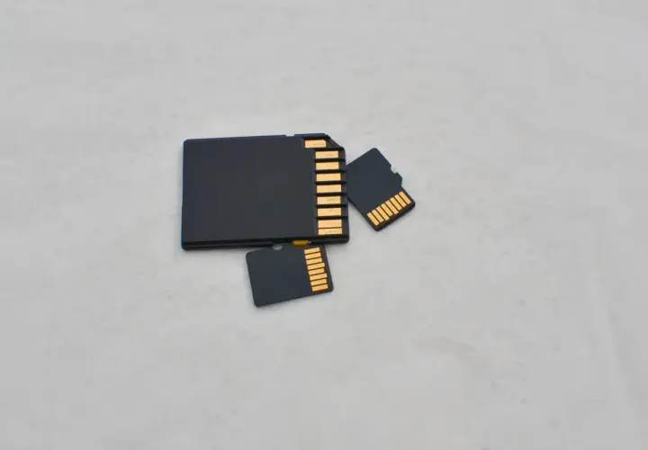 Porównanie rozmiarów: duża karta SD i dwie mniejsze karty microSD (TF). Różnica w wielkości jest oczywista.