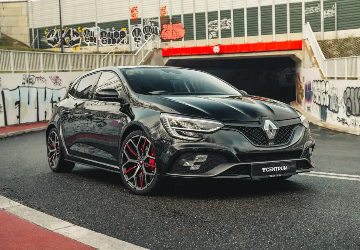 Czarny Renault Megane RS na tle graffiti. Idealny wybór dla tych, którzy szukają sportowych emocji i atrakcyjnego **leasingu Renault Megane**.