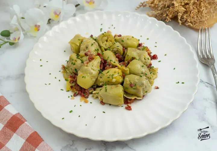Alcachofas de bote salteadas con jamón y cebolla, un plato sencillo y delicioso. ¡Perfecto para tus recetas con alcachofas de bote!
