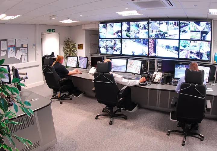Operatorzy monitorują obraz z kamer CCTV na wielu ekranach. To centrum dowodzenia, gdzie cctv co to jest, jest kluczowe dla bezpieczeństwa.