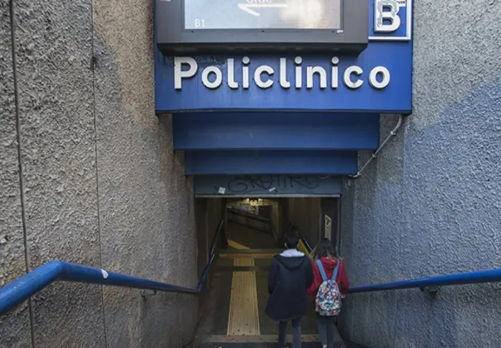 Due persone scendono le scale verso l'ingresso della stazione policlinico metro B.