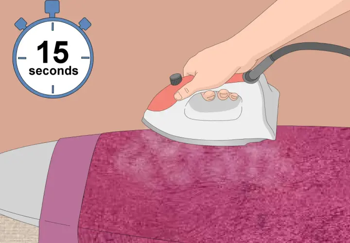 Ironing pink polyester velvet with steam for 15 seconds.