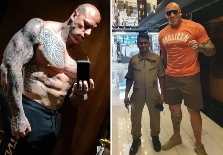 Martyn Ford, imposant comme Shao Kahn, pose avec un homme en uniforme. Le colosse est couvert de tatouages.