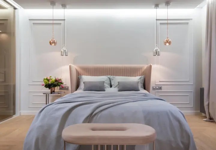 Achieve that hotel bed at home feeling with this plush, inviting bedroom setup. Soft linens, a cozy throw, and elegant lighting create a serene sanctuary.