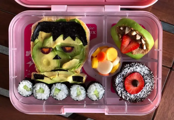 Fun vegan bento ideas! Frankenstein avocado toast, apple monster, sushi, fruit salad, and a chocolate cake.