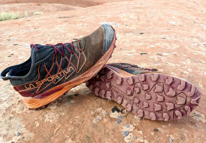 Trail running shoes with synthetic uppers, showing dirt and wear from a rugged adventure. Synthetic uppers are man-made materials, offering durability and water resistance.