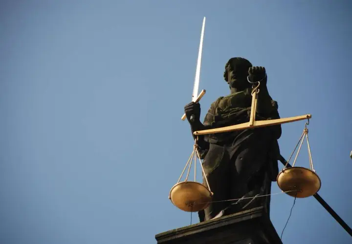 Temida z mieczem i wagą symbolizuje sprawiedliwość. Zastanawiasz się, ile bierze komornik za alimenty? Prawo jest po Twojej stronie.