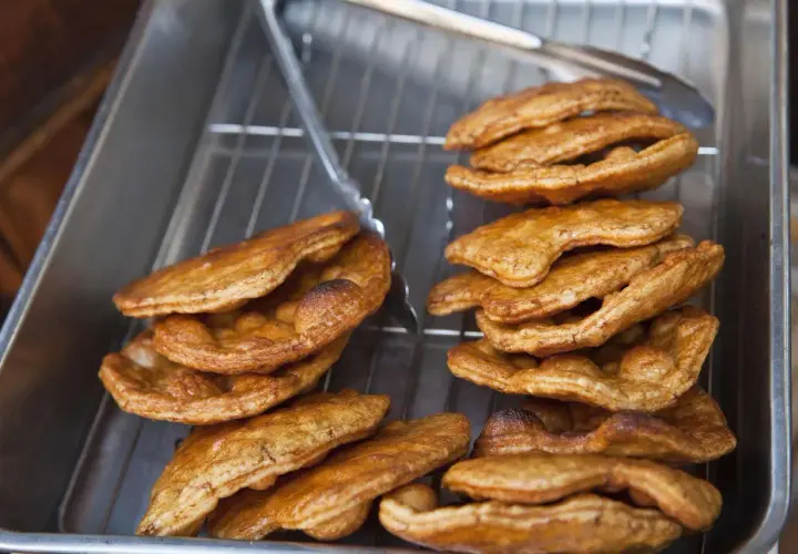 Golden brown, freshly fried Japanese rice crackers cooling on a rack. This image captures the essence of a delicious Japanese rice crackers recipe.