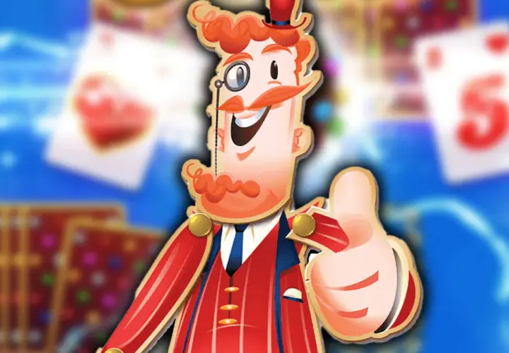 Postać z gry Candy Crush Saga z kciukiem w górę, w tle karty do gry.