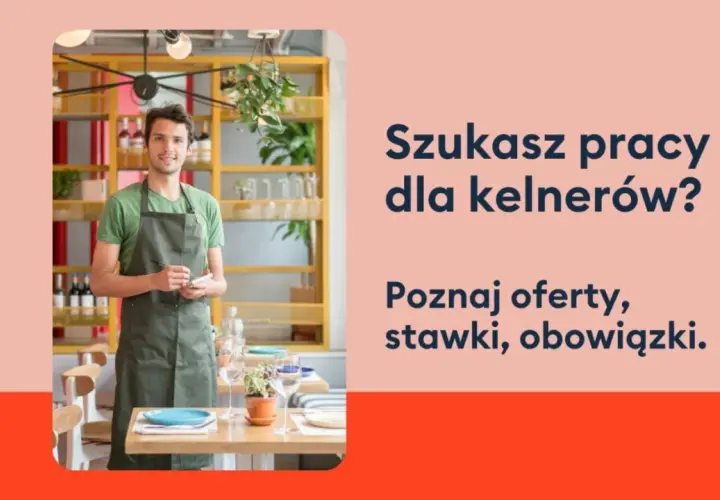 Uśmiechnięty kelner w fartuchu stoi w restauracji, gotowy przyjąć zamówienie. Szukasz pracy dla kelnerów?
