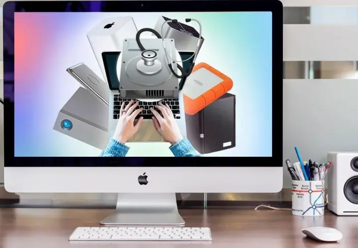 Festplatte wird nicht erkannt? Diagnose mit Stethoskop auf Laptop-Tastatur. Externe Laufwerke und Apple-Produkte im Hintergrund.