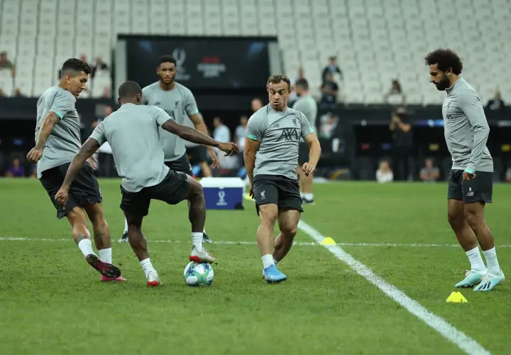 Fußballer im Trainingsanzug üben auf dem Rasen. Intensive athletische Trainingseinheit mit Fokus auf Ballkontrolle und Bewegung.