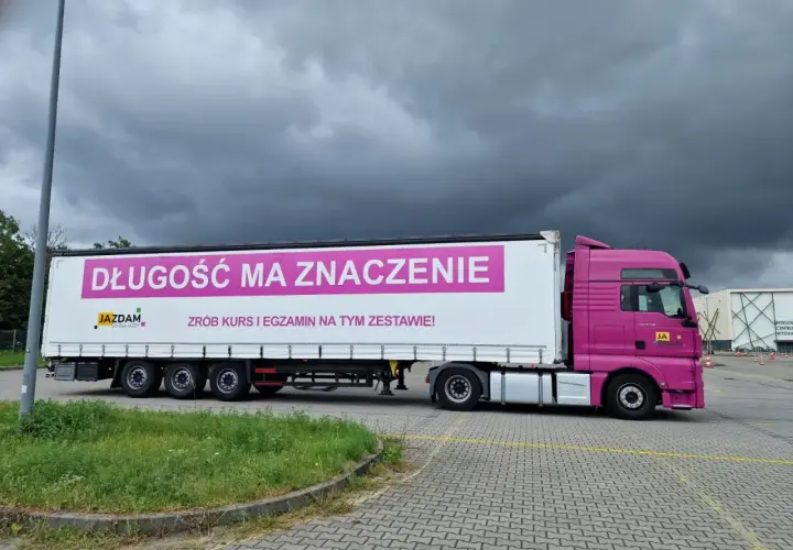 Różowy ciągnik z naczepą, na której widnieje napis "DŁUGOŚĆ MA ZNACZENIE". Idealny do nauki manewrów z dopuszczalną masą całkowitą zespołu pojazdów c+e.