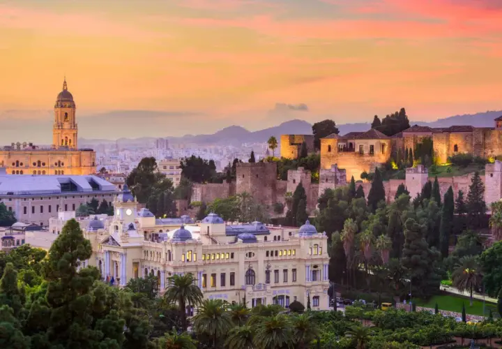 Atardecer en Málaga, con la Alcazaba iluminada y la Catedral al fondo. Un lugar perfecto para disfrutar de actividades culturales y vistas impresionantes.