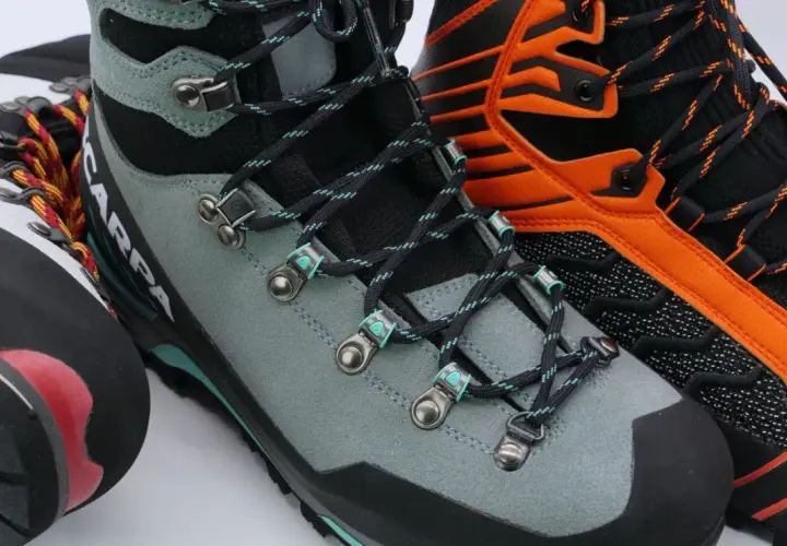 Close-up of three pairs of mountaineering boots, showing lacing details. Learn how to fit mountaineering boots for your next adventure.