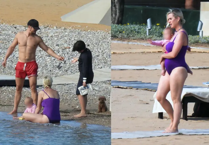 Katy Perry z dziećmi na plaży. Wokalistka w fioletowym stroju kąpielowym trzyma na rękach córkę.