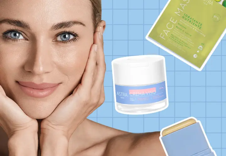 Donna con mani sul viso, circondata da prodotti Astra per la cura della pelle, per una skin longevity radiosa.