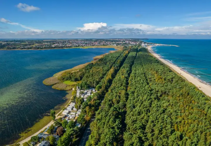 Półwysep Helski z lotu ptaka: las sosnowy, plaża, morze i zatoka. Widoczny kemping i zabudowania.