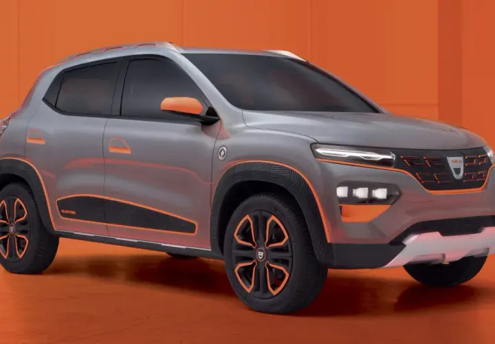 Szary Dacia Spring Electric z pomarańczowymi akcentami, prezentujący nowoczesny design miejskiego SUV-a.