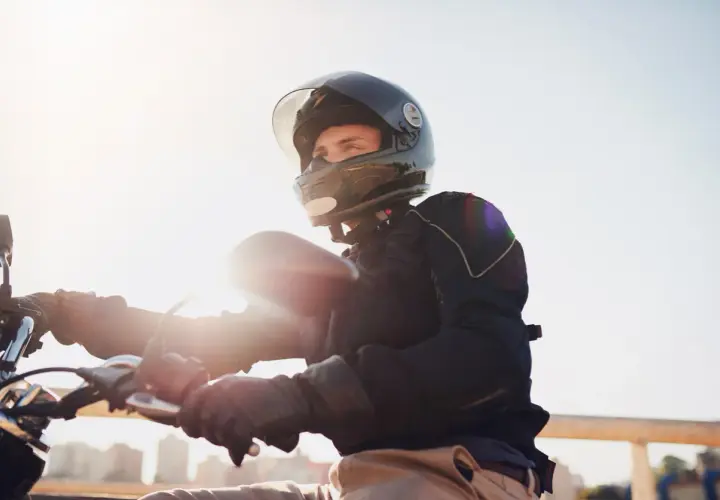 Giovane con casco integrale, pronto a partire in motorino. L'obbligo casco motorino è fondamentale per la sicurezza.