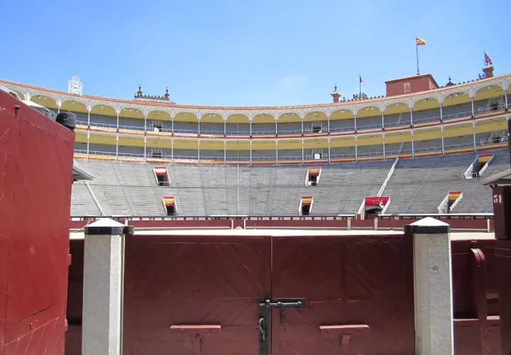 Las gradas vacías del **museo de las ventas**, con sus banderas españolas, esperan la próxima corrida.