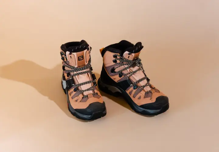A pair of tan Salomon hiking boots with black accents and laces. These boots are designed for rugged terrain, but how much do hiking boots weigh?