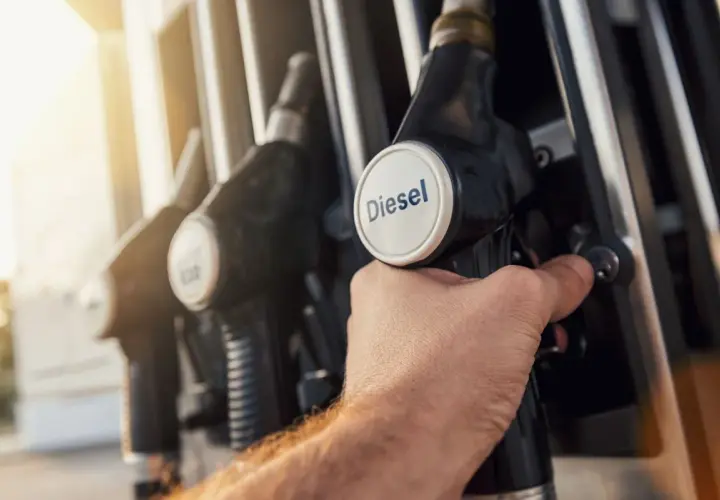 Dłoń trzymająca pistolet do tankowania z napisem "Diesel". Zastanawiasz się, jak zmniejszyć spalanie w dieslu?
