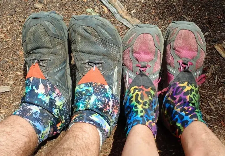 Four pairs of hiking shoes with colorful gaiters. The question "do boots run bigger than shoes" is irrelevant here.