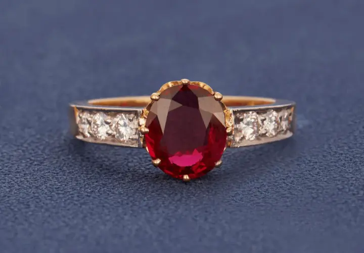 Ein Ring mit einem ovalen, tiefroten Edelstein, der an einen Rubin erinnert. Der Unterschied zwischen Granat und Rubin ist oft die Farbe.