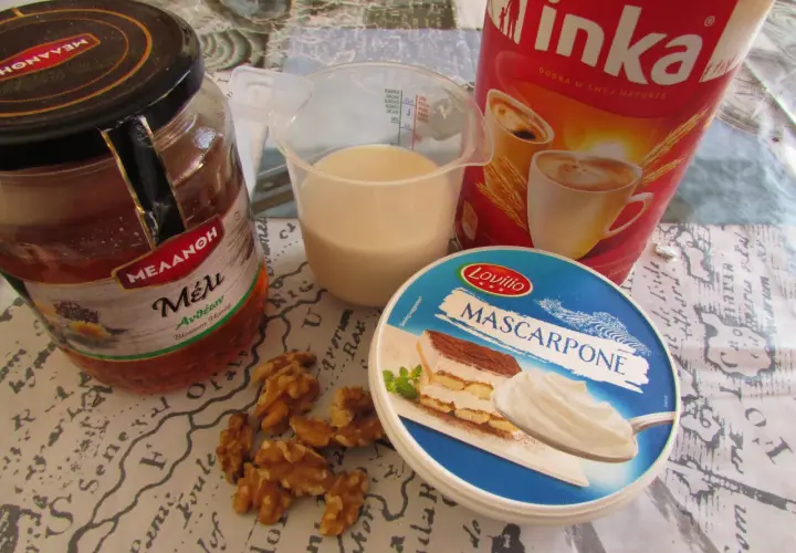 Składniki na kawę Inka z mlekiem: słoik miodu, kubek mleka, opakowanie serka mascarpone, orzechy włoskie i puszka kawy Inka.