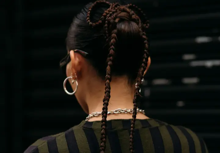 Peinados para conciertos: trenzas recogidas en forma de moño con dos coletas largas.