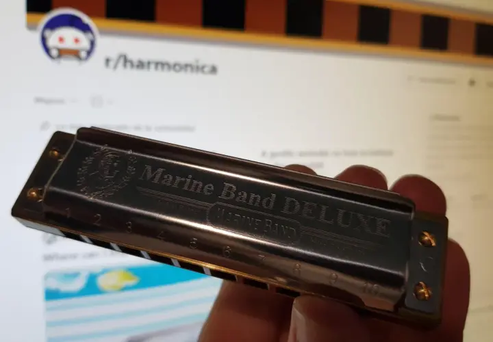 Harmonijka Marine Band DELUXE, z wygrawerowanymi nutami i numerami, gotowa do zagrania melodii.