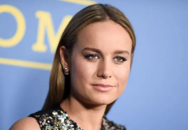 Brie Larson med lila eyeliner och glittrig klänning. Hon är känd för sina roller i filmer med brie larson.
