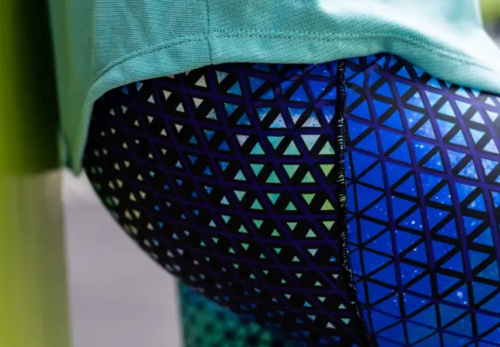 Close-up of a person wearing blue leggings with a geometric triangle pattern. This image could be part of a tutorial on how to sew leggings.