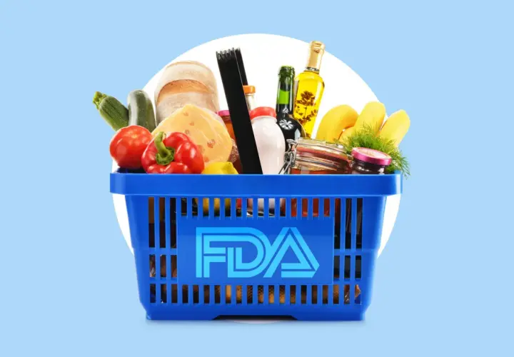 A blue shopping basket filled with groceries, including bread, cheese, and produce, with the FDA logo prominently displayed. This image represents food safety regulations overseen by the FDA and USDA.