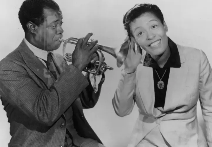 Louis Armstrong gra na trąbce, a Ella Fitzgerald słucha, zastanawiając się, co to scat.
