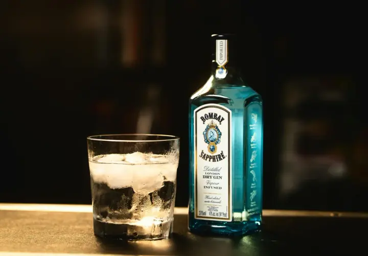 Szklanka z lodem i butelka ginu Bombay Sapphire. Tani tonik do rzemieślniczego ginu to strata aromatu, gin traci swój charakter.