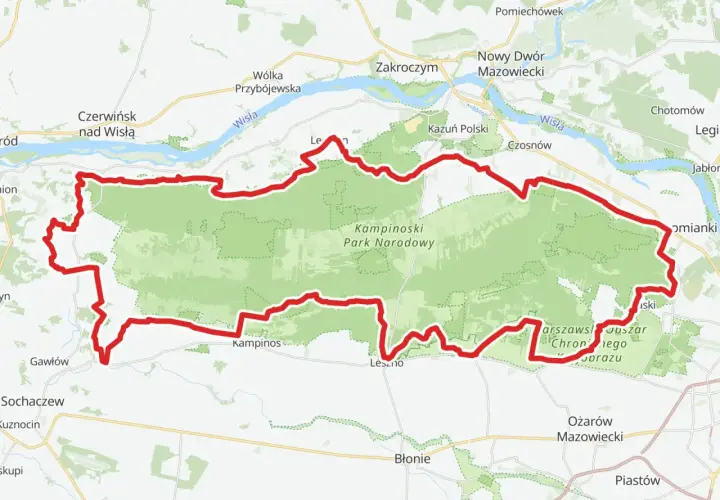 Mapa z zaznaczonym Kampinoskim Szlakiem Rowerowym, biegnącym przez Kampinoski Park Narodowy, w pobliżu Wisły i miejscowości takich jak Zakroczym czy Ożarów Mazowiecki.