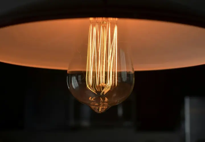 Żarówka Edisona z widocznym żarnikiem, idealna jako jaka żarówka do lampki nocnej, tworzy ciepły, przytulny blask.