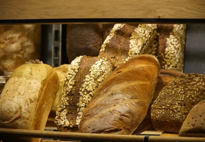 Różnorodne pieczywo, w tym bochenki z płatkami owsianymi i słonecznikiem. Szukasz pieczywo, jakie nie zawiera glutenu?