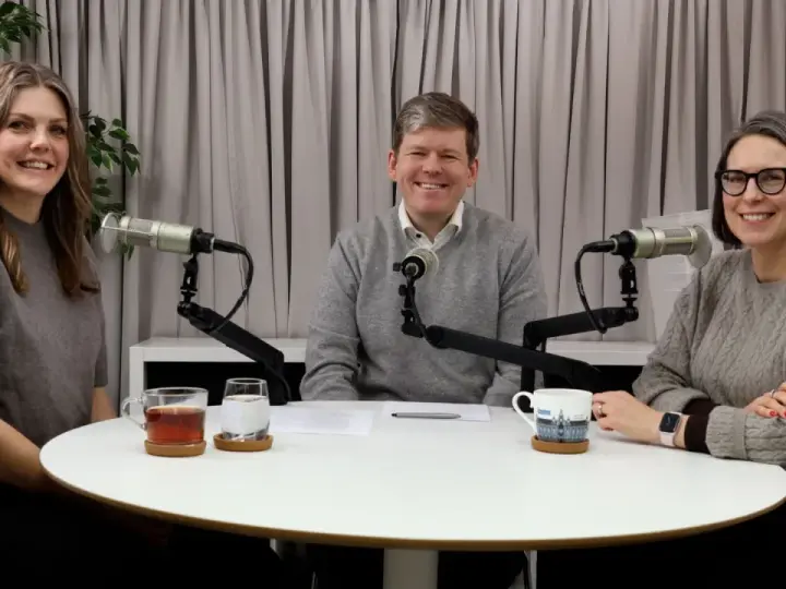 Tre personer sitter vid ett runt bord med mikrofoner framför sig. De verkar spela in en podcast, kanske om arv, synonymt med det som lämnas kvar.