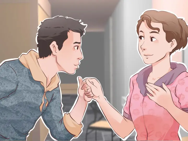 Un garçon tient la main d'une fille, un geste tendre pour lui montrer comment plaire à un garçon.