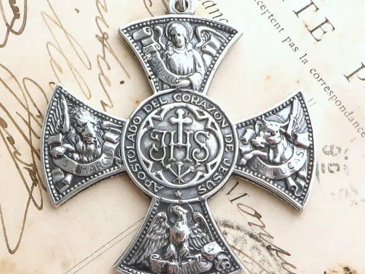 Srebrny krzyż z symbolami ewangelistów: lew (św. Marek), anioł (św. Mateusz), wół (św. Łukasz) i orzeł (św. Jan).
