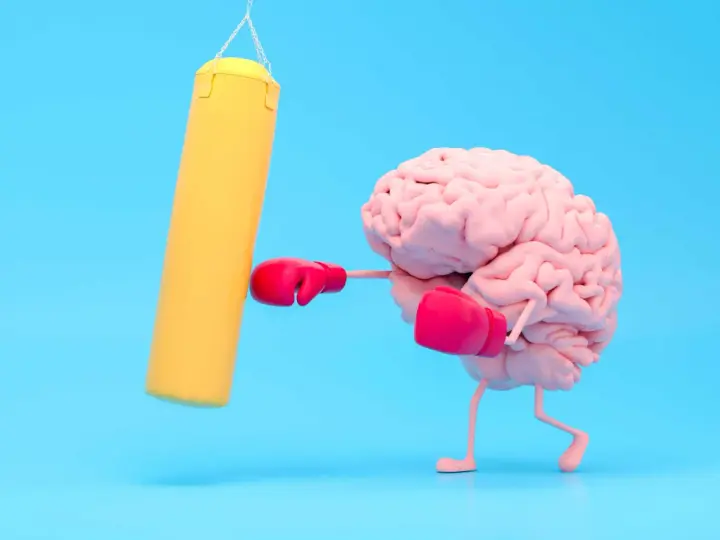 Cervello con guantoni da boxe rosa colpisce un sacco giallo, un modo per risollevare l'umore.