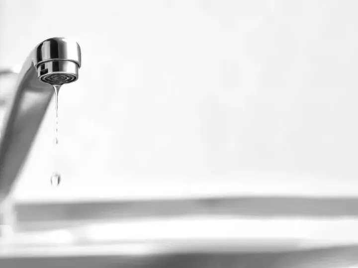 Un rubinetto perde acqua da sopra, goccia dopo goccia, uno spreco silenzioso.