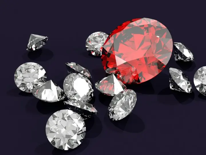 Wokół dużego, czerwonego rubinu, znanego z magicznych właściwości, rozsypane są błyszczące diamenty.