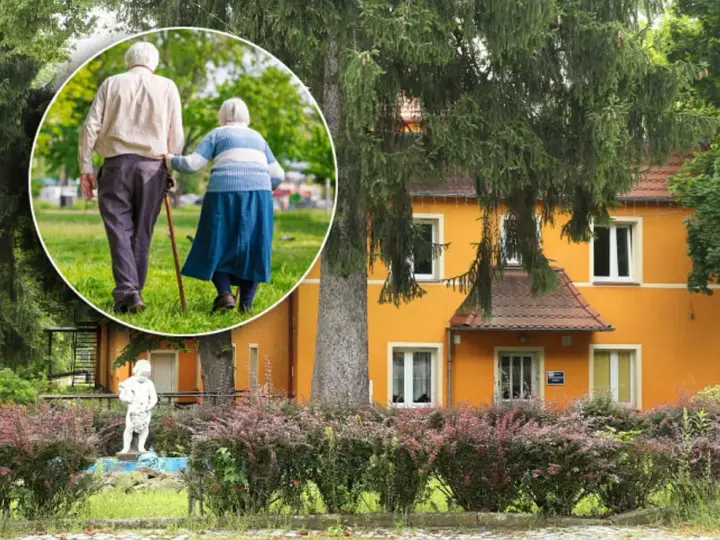 Spacer po parku przy sanatorium w Przerzeczynie Zdroju. Starsza para, wspierając się laską, cieszy się spokojnym popołudniem.