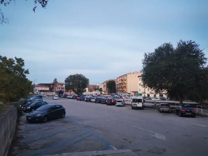 Ampio parcheggio a Matera, con molte auto parcheggiate in file ordinate. Ideale per chi cerca dove parcheggiare a Matera.