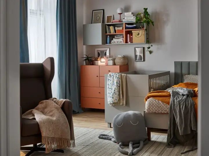 Jak przygotować stylowy kącik dla dzieci który nie psuje estetyki sali? Wygodny fotel, łóżeczko i półki tworzą przytulne miejsce.