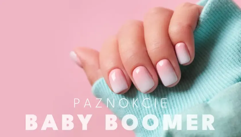 Dłoń z paznokciami w stylu baby boomer, delikatny gradient różu i bieli. Idealny manicure dla każdej kobiety.